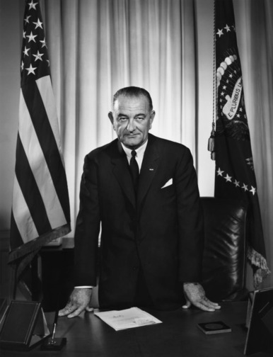 Lyndon B. Johnson standing over desk photo Lyndon B. Johnson standing over desk photo