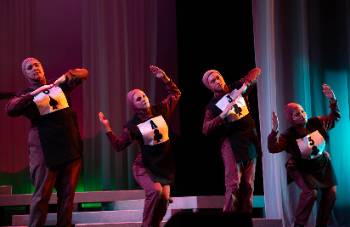 A photo depicting a performance of "Kingdom of Cards," depicting four actors dressed as various cards.