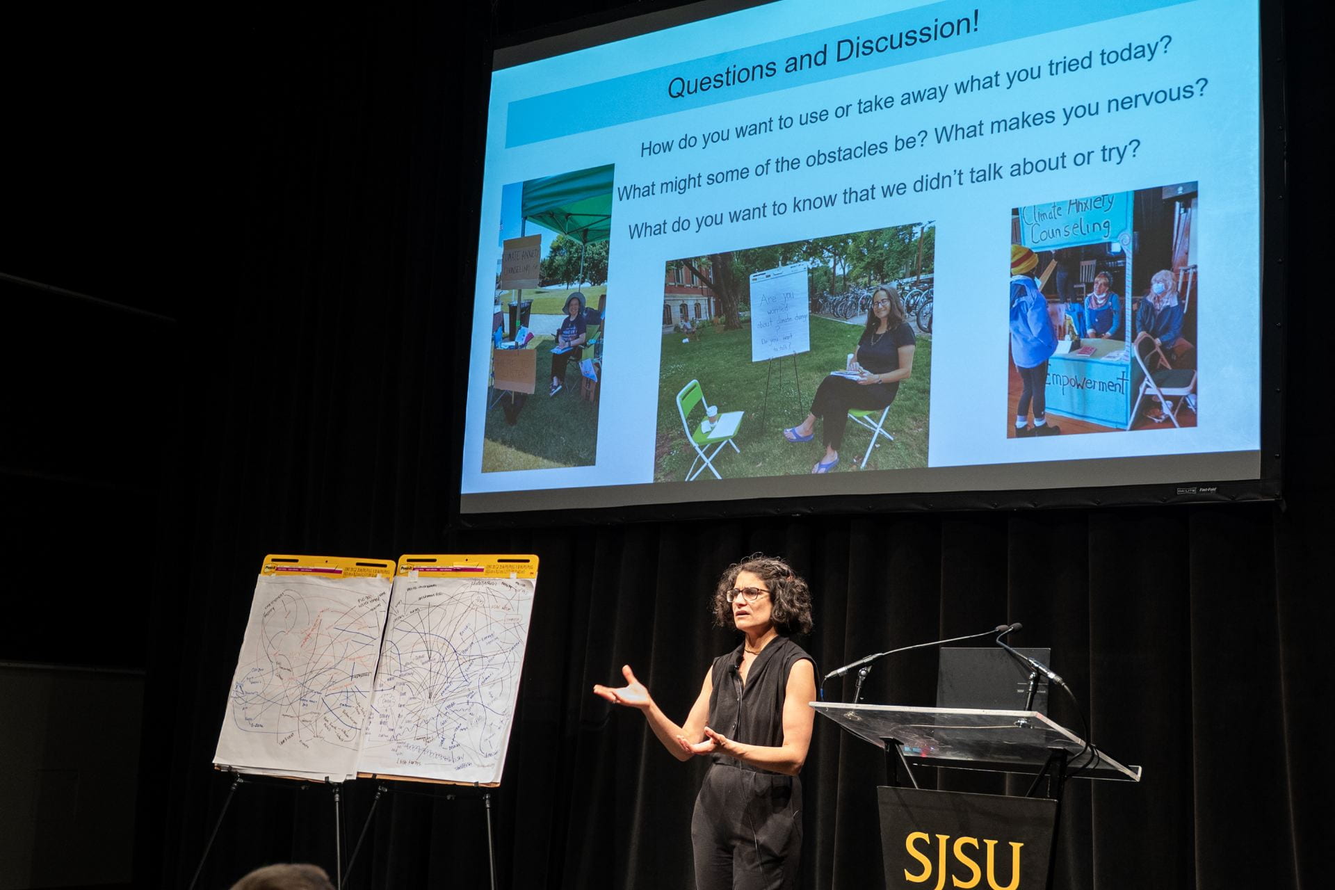 one person on a stage with an image in the background