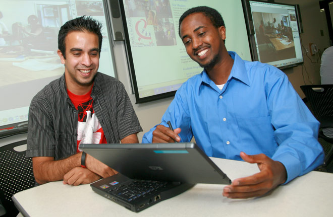 Two students with laptops