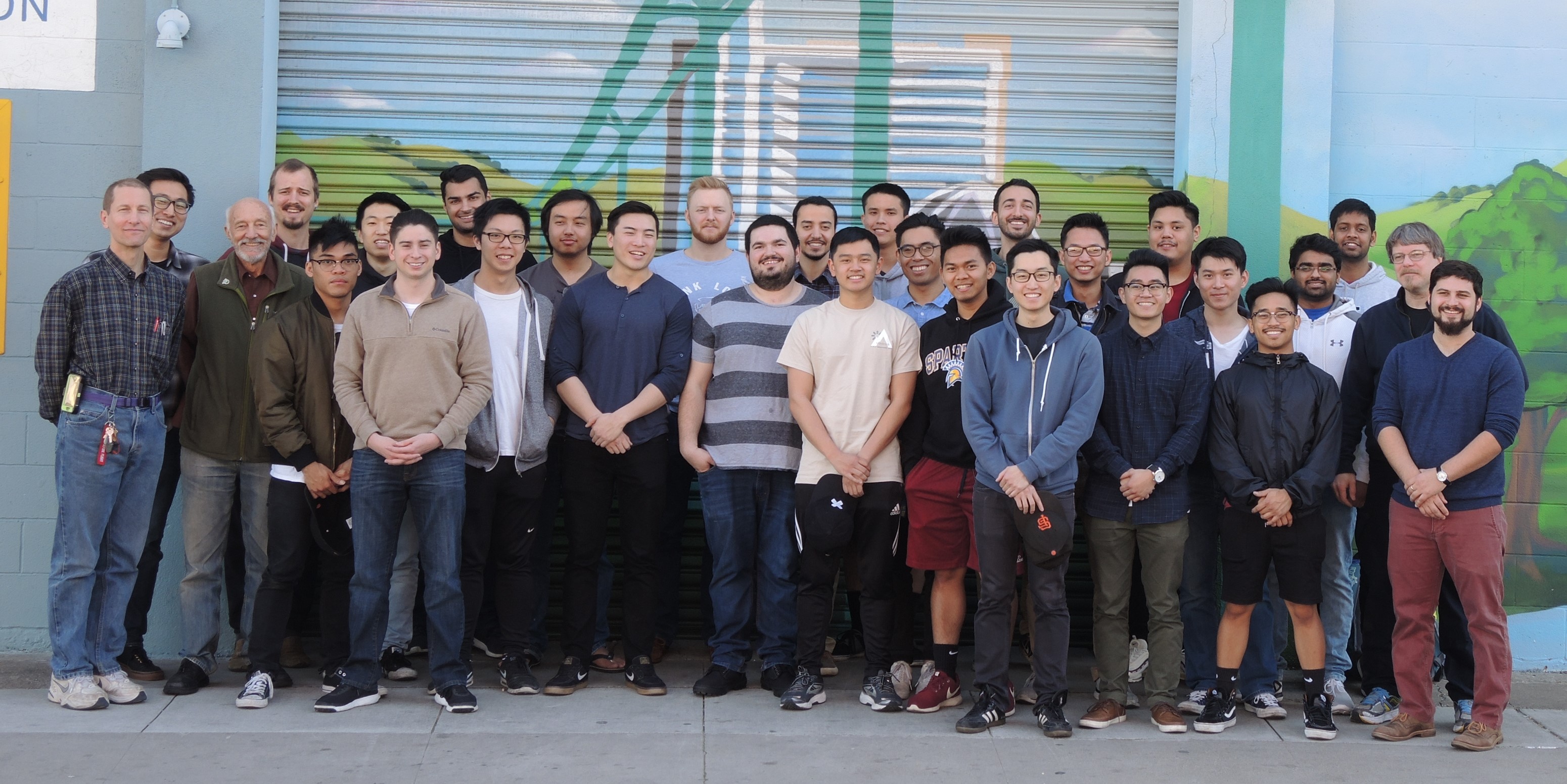 Image of Spartan Superway team group in front of a wall.