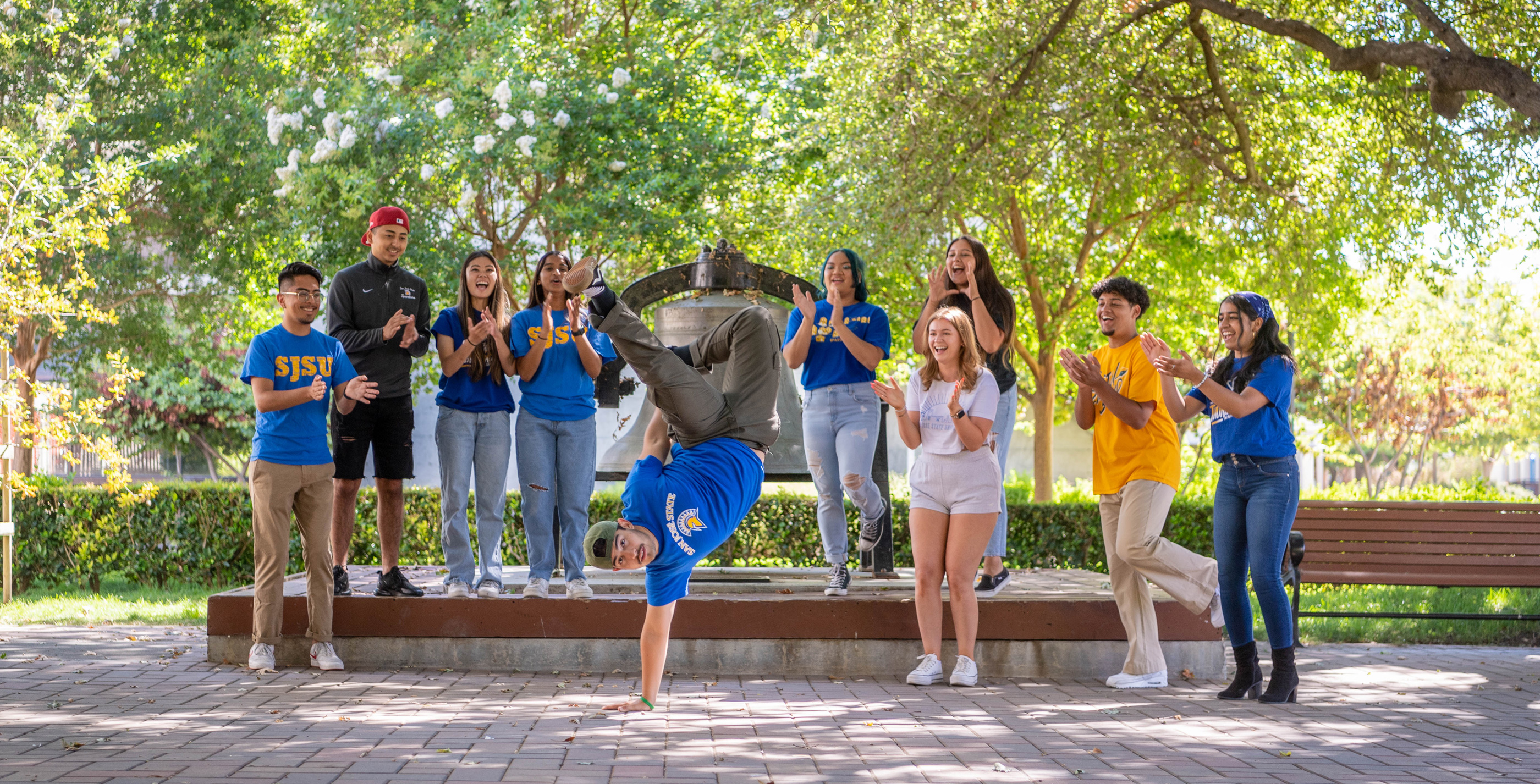 Students gathering around tower bell area to dance and have fun.